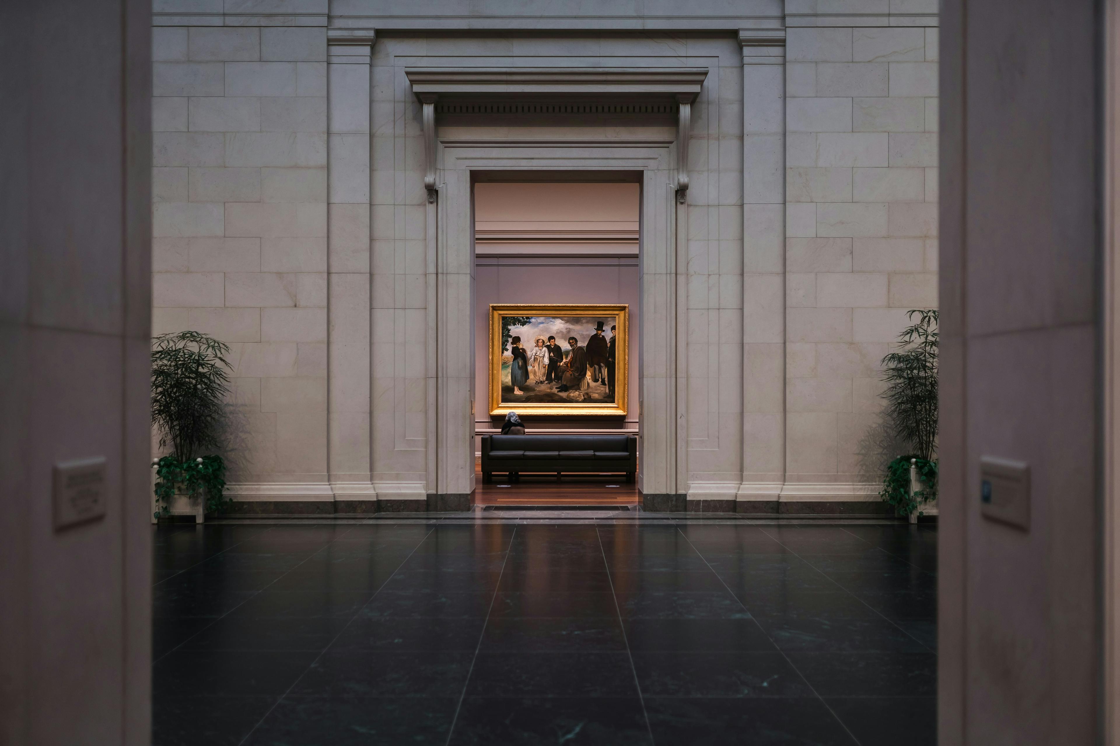 Gallery visitors observing landscape paintings